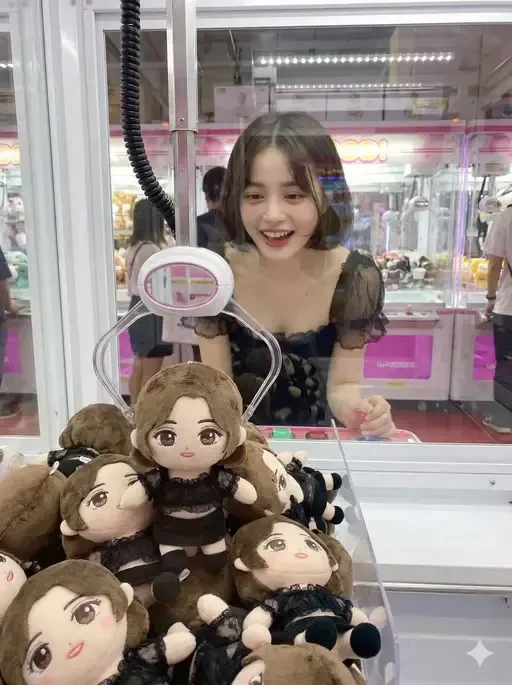 person at arcade UFO catcher machine