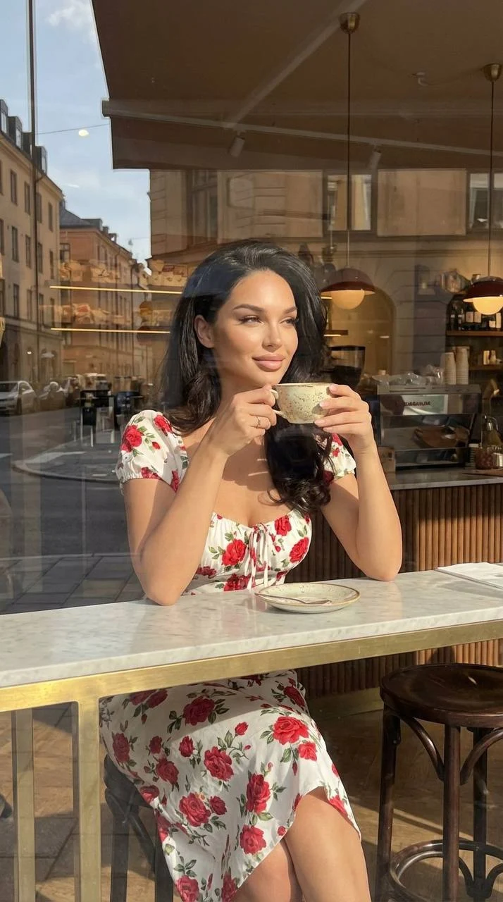 Girl with Coffee at Cafe Window